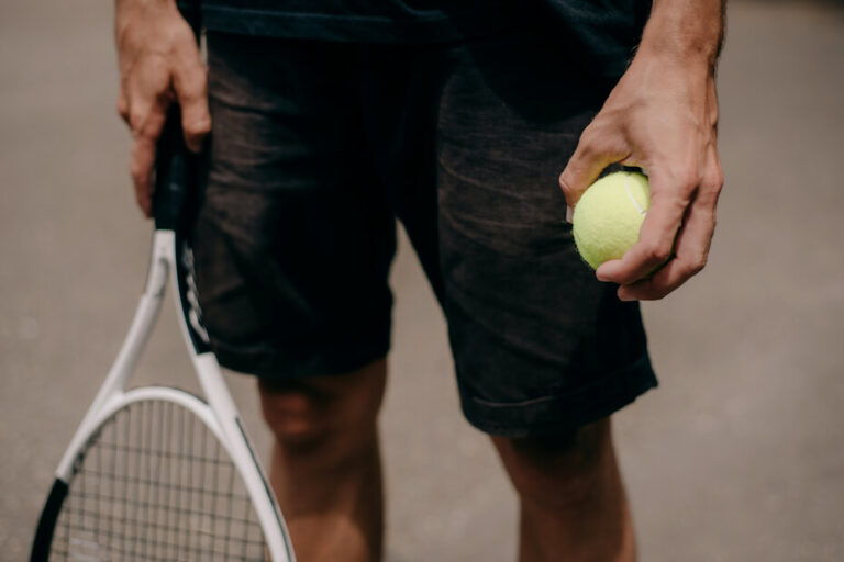 A player holding a tennis ball and a racket
