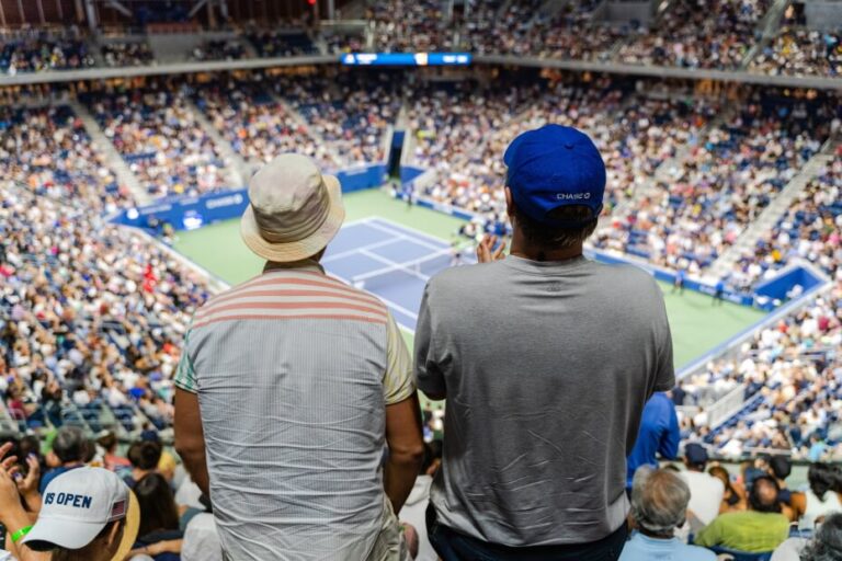 Two fans watching a tennis match